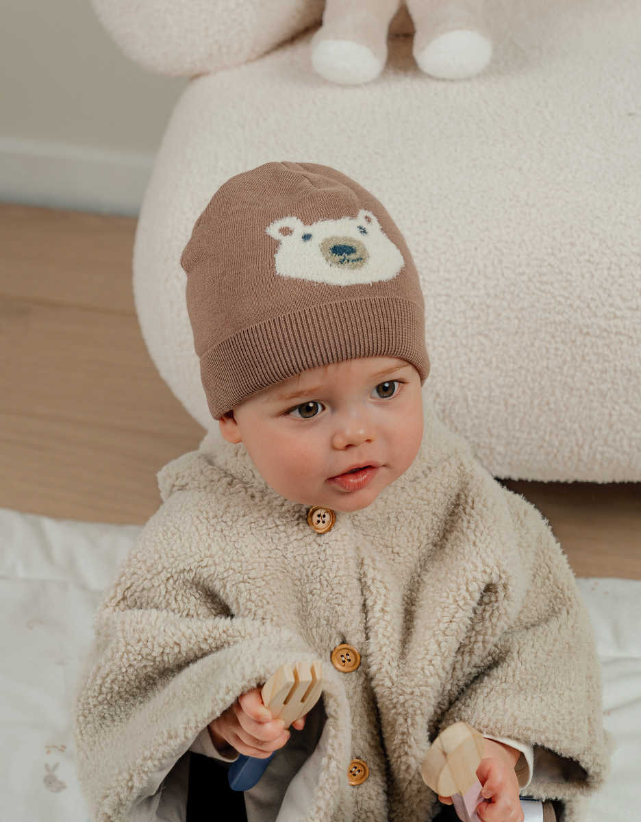 Brown knit hat with bear design
