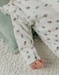 Witte velours baby pyjama met vogelprint
