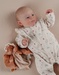 Light pink velour baby pyjamas with floral print and ruffles
